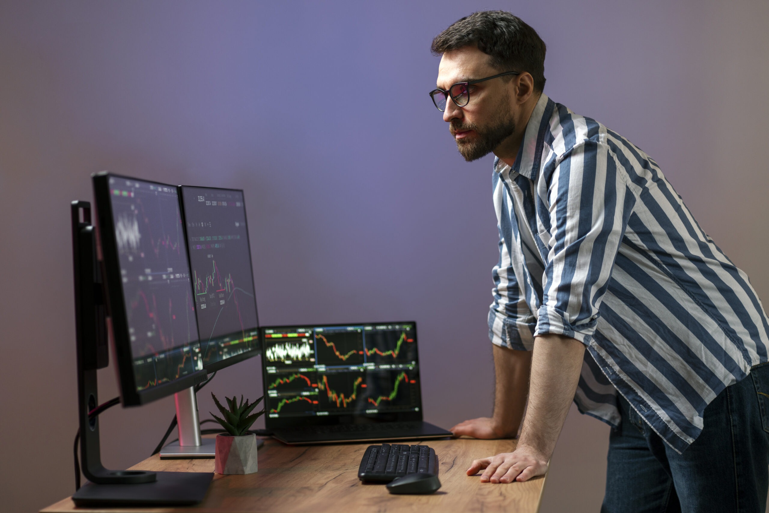 Engineer monitoring multiple screens in a control room